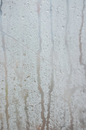Rainwater drops on a transparent background made of waterproof fabric. Texture and abstract...