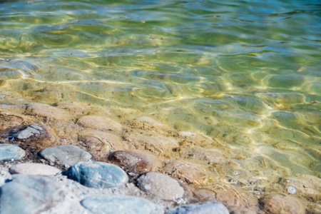 Waves on the seashore. A clear sunny day. Clear, clean sea water. Holidays on the coast. Natural background and texture.の写真素材