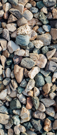 The background is made of stones of different sizes and colors. The texture of natural stones.の写真素材