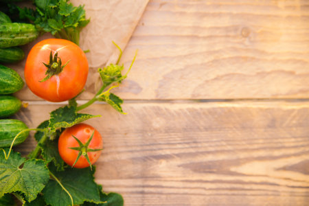 Fresh vegetables on a wooden background. Empty space for the text. Cucumbers, tomatoes, garlic, dill. Top view.の写真素材
