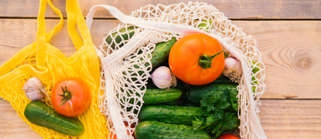 Fresh juicy vegetables, products in a reusable shopping bag, a string bag made of recycled materials, on a wooden table in the garden. Vegetarianism. No plastic. Eco-friendly lifestyle.の写真素材