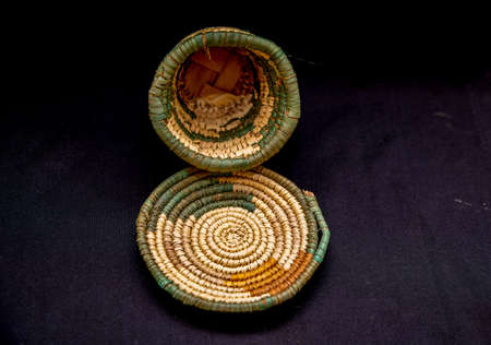 Empty wicker basket on black backgroundの写真素材
