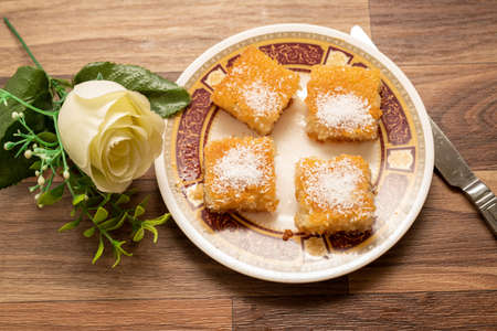 A sweet Arabic basbousa dish on a wooden background