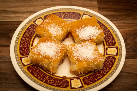 A sweet Arabic basbousa dish on a wooden backgroundの写真素材