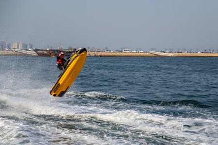 A man on a jet ski jumps over the sea in Qatar.の写真素材