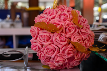 wedding bouquet of pink roses on a table in a restaurantの写真素材