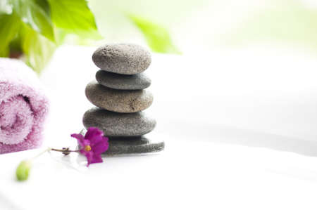 spa stones and magenta flower on the white backgroundの写真素材