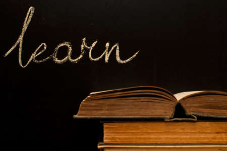 learn written on school blackboard with books