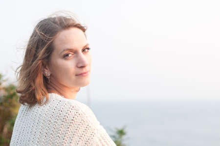 young woman is enjoing the sea sunsetの写真素材