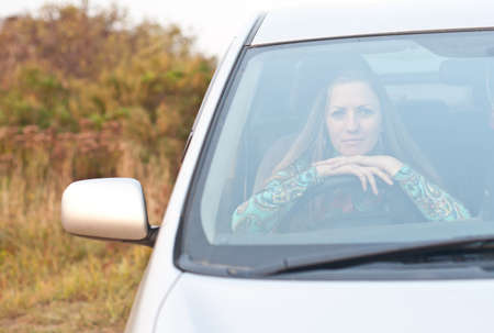 young woman driver beginner is sitting in the car