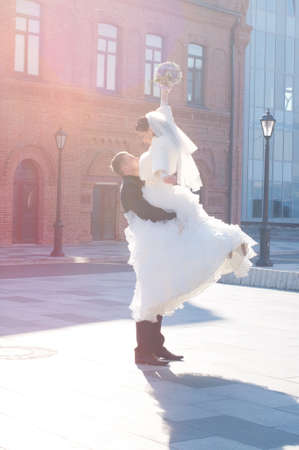 Happy Bride And Groom Embracing Outdoorsの写真素材