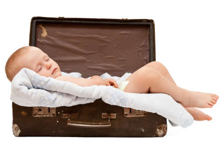 baby sleeps in the old shabby suitcaseの写真素材