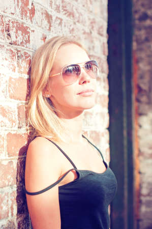 Young beautiful woman is outdoors, on the old streetsの写真素材