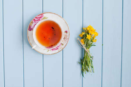 Summer blooming bouquet of wild yellow flowers on the tableの写真素材