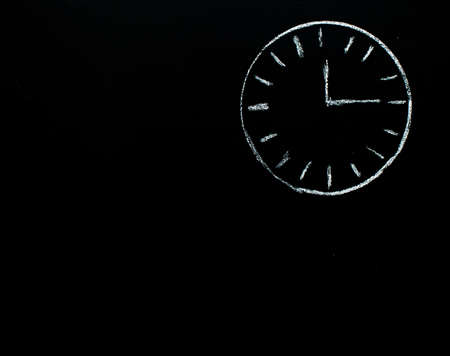 clock drawn by the chalk on the blackboardの写真素材
