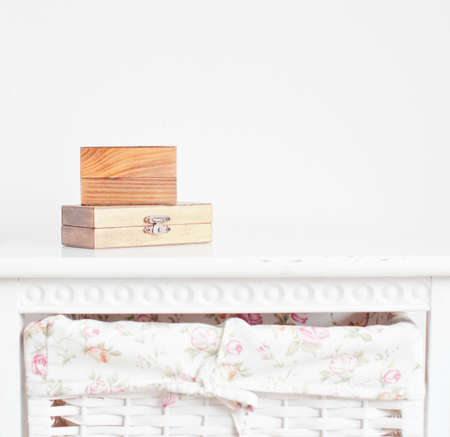 Two wooden boxes on the white bedside tableの写真素材