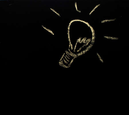 light bulb is drawn by the chalk on the blackboradの写真素材