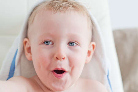 laughing baby boy is happy after bathの写真素材