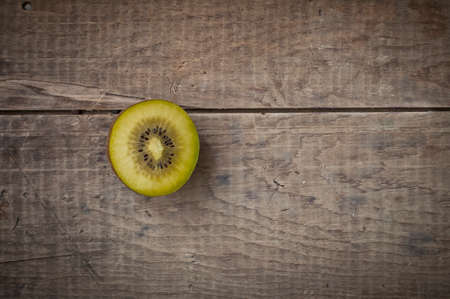 half kiwifruit on rustic vintzge wooden tableの写真素材