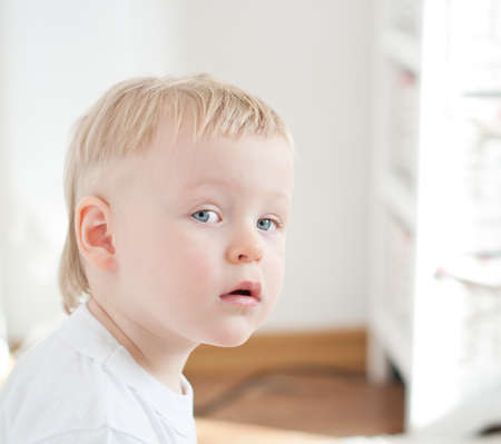 little serious boy is looking at the cameraの写真素材