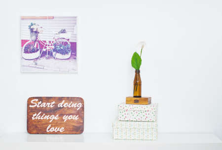 Bicycle - flower bed on picture and flower in the bottle and Motivating grunge wooden poster quote Start doing things you loveの写真素材