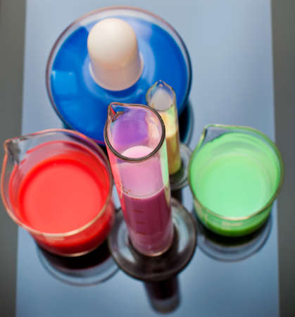 Tubes, bulb and measuring glass on the glass backgroundの写真素材