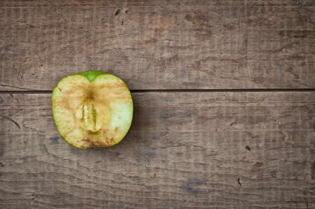 Old dry sear green apple on rustic vintage wooden tableの写真素材
