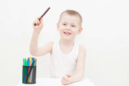 Laughing 4 years old kid is drawingの写真素材