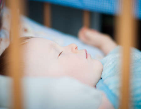 cute little Baby boy is sleeping in the crib