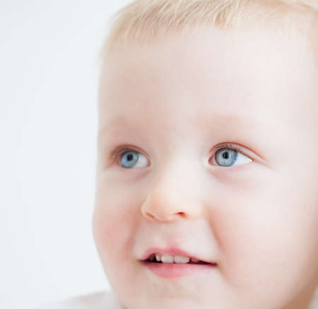 cute baby boy is looking at side and smilingの写真素材