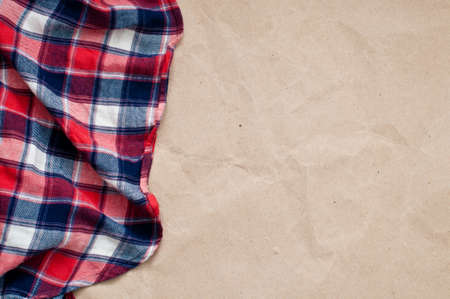 Red blue checked shirt and craft paper backgroundの写真素材