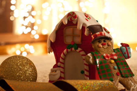 christmas eve with gingerbread man and house and golden defocused lightsの写真素材