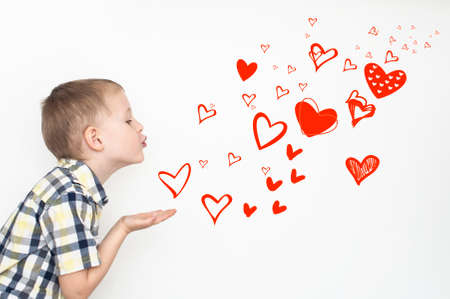 Little kid is sending heart shaped kissesの写真素材
