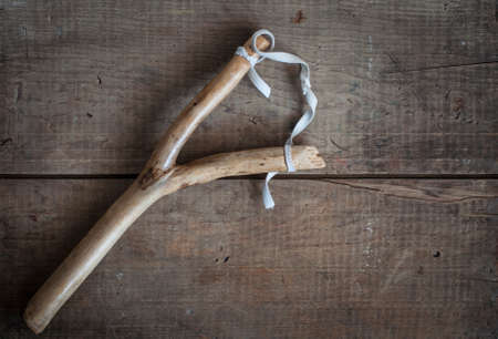 old vintage slingshot toy on wooden backgroundの写真素材