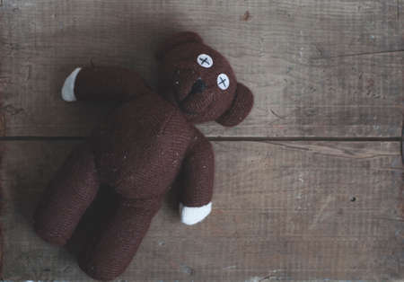 old vintage teddy bear toy on wooden backgroundの写真素材