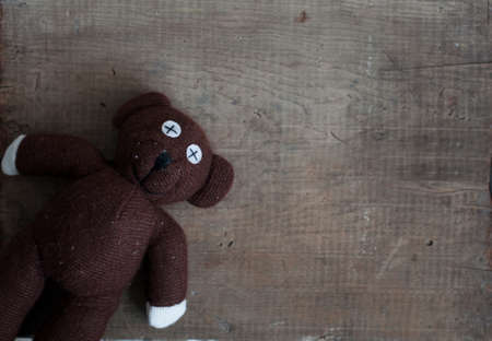 old vintage teddy bear toy on wooden backgroundの写真素材