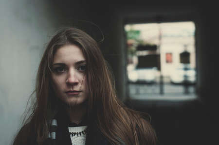 Young pensive long haired sacred girl standing outside aloneの写真素材