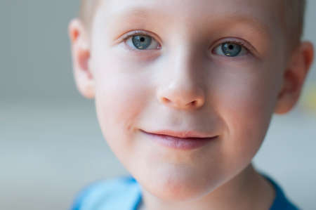 smiling little boy is looking at the cameraの写真素材