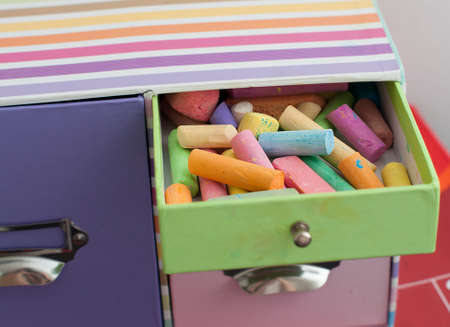 colorful chalk in multicolored box in child's room