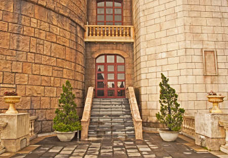 balcony in the medieval castle, stairs, ledge and decorative treesのeditorial素材
