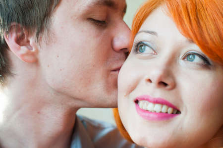 happy family couple man and woman are kissingの写真素材