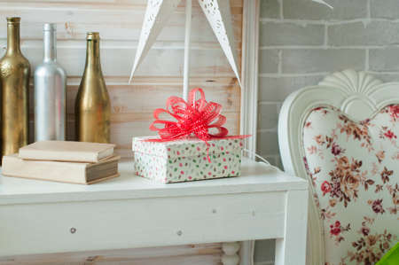 lovely giftbox with red ribbon on the table in bedroomの写真素材