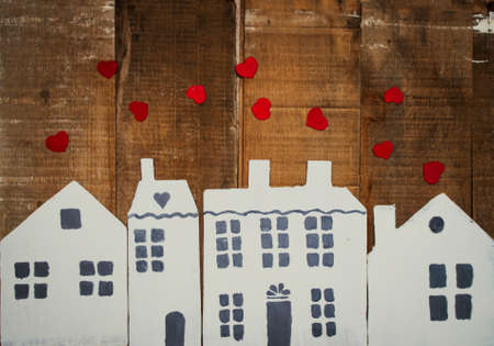 cardboard houses and red hearts on wooden backgroundの写真素材