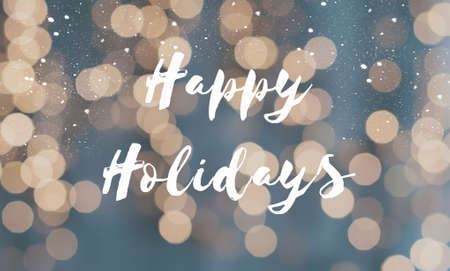 Greeting card happy holidays with defocused christmas lights as backgroundの写真素材