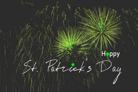 Happy saint patrick's day words over green firwork night backgroundの写真素材