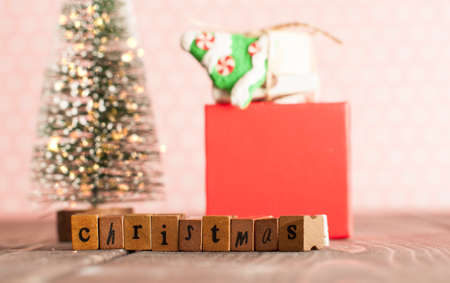 Christmas evergreen tree with lights and gifts on the table in pink nursery roomの写真素材