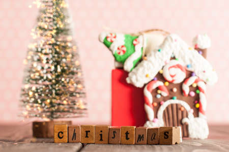 Christmas evergreen tree with lights and gifts on the table in pink nursery roomの写真素材
