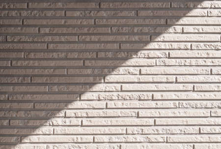 Background textured as finishing material of the wall made of imitation  of narrow beige brickの写真素材