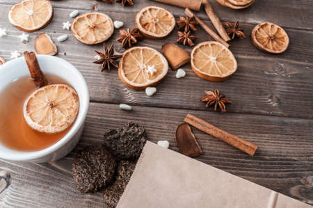 Dried oranges, cinnamon sticks and anise stars on rustic wooden tableの写真素材