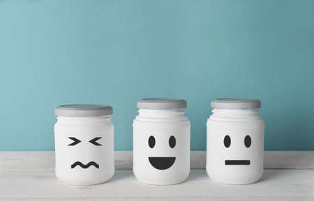 Review metaphor with  smiles on three white jars on the kitchen in nordic homeの写真素材